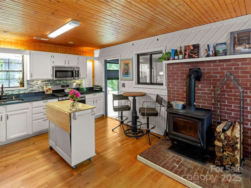 44 Sutton Knob Road, Candler, NC 28715.  MLS# CAR4252708, YatesRealty ID 26806. Kitchen & wood burning stove