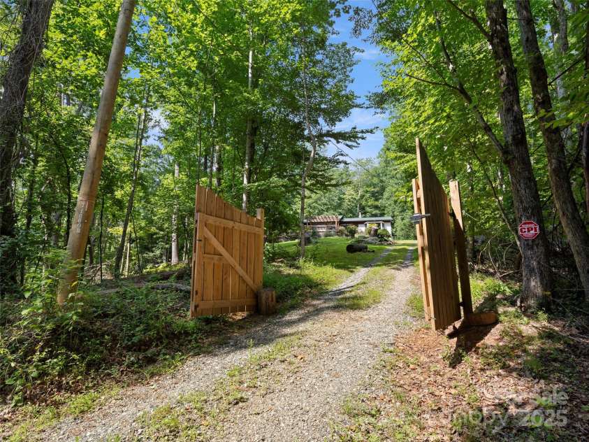 44 Sutton Knob Road, Candler, NC 28715.  MLS# CAR4252708, YatesRealty ID 26806. Privacy gate