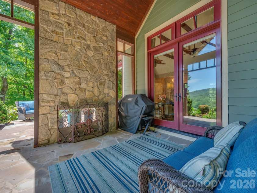 161 Chattooga Run, Hendersonville, NC 28739.  MLS# CAR4385295, YatesRealty ID 26812. Double-sided fireplace perfect for cozy fall nights