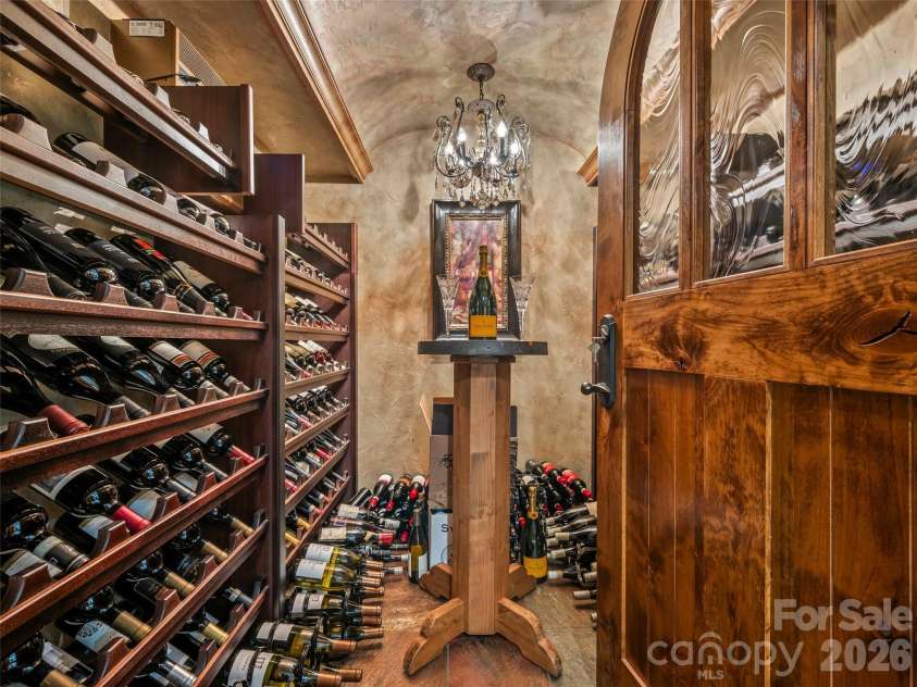 161 Chattooga Run, Hendersonville, NC 28739.  MLS# CAR4385295, YatesRealty ID 26812. Old-world wine cellar with timeless character, thoughtfully designed for your prized vintages.
