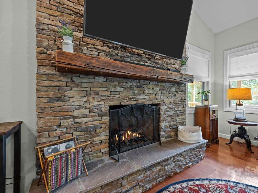 305 Pound Mill Branch Road, Green Mountain, NC 28740.  MLS# CAR4268058, YatesRealty ID 26814. Floor to ceiling stone fireplace w/ gas logs.
