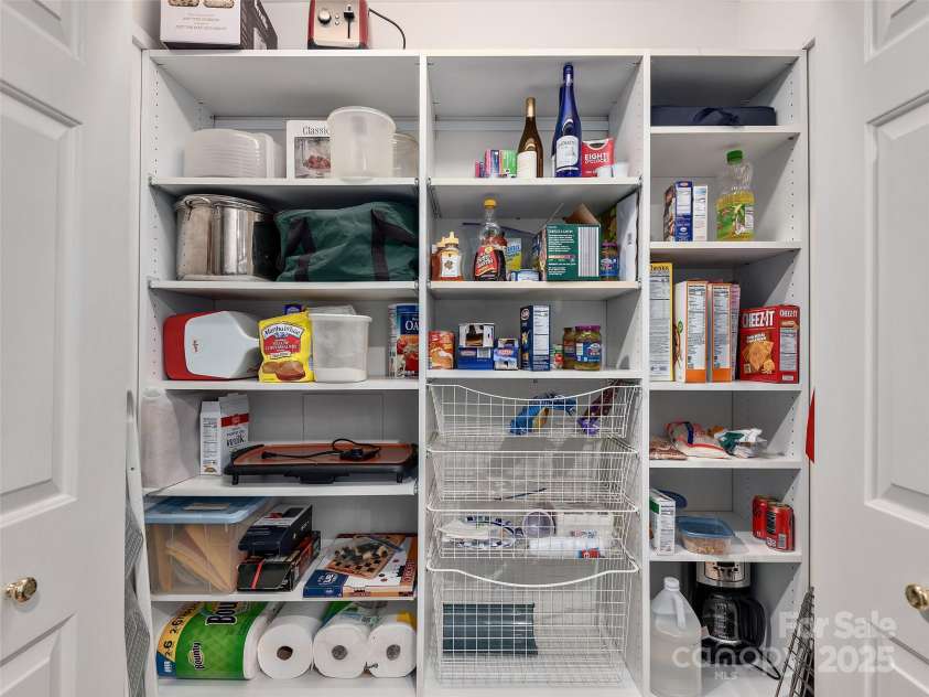 30 Beaumont Drive, Hendersonville, NC 28739.  MLS# CAR4282917, YatesRealty ID 26829. Pantry with washer/dryer hook ups behind shelves.