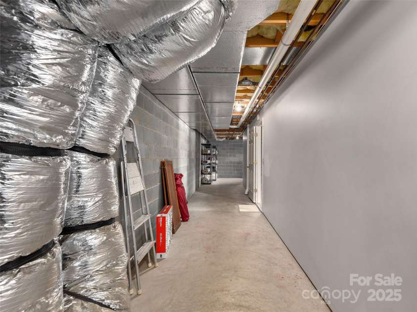 30 Beaumont Drive, Hendersonville, NC 28739.  MLS# CAR4282917, YatesRealty ID 26829. Unfinished Basement hallway