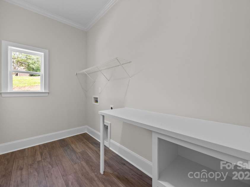 8605 Carly Lane, Mint Hill, NC 28227.  MLS# CAR4187633, YatesRealty ID 26845. Laundry room with built in table and storage