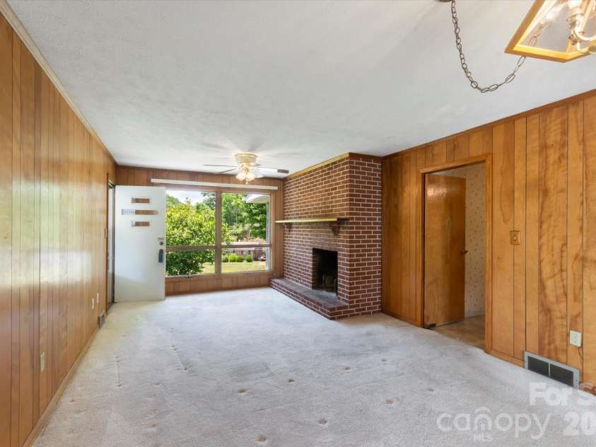 295 Bramlett Drive, Waynesville, NC 28785.  MLS# CAR4381280, YatesRealty ID 26852. Den with dining room area