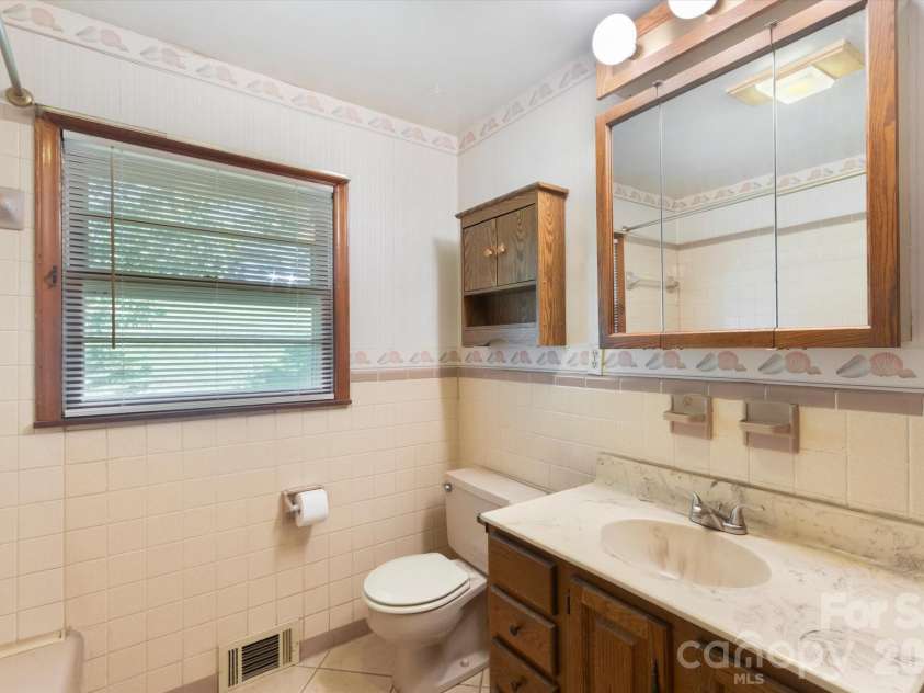 295 Bramlett Drive, Waynesville, NC 28785.  MLS# CAR4381280, YatesRealty ID 26852. Primary bath with original ceramic tiles