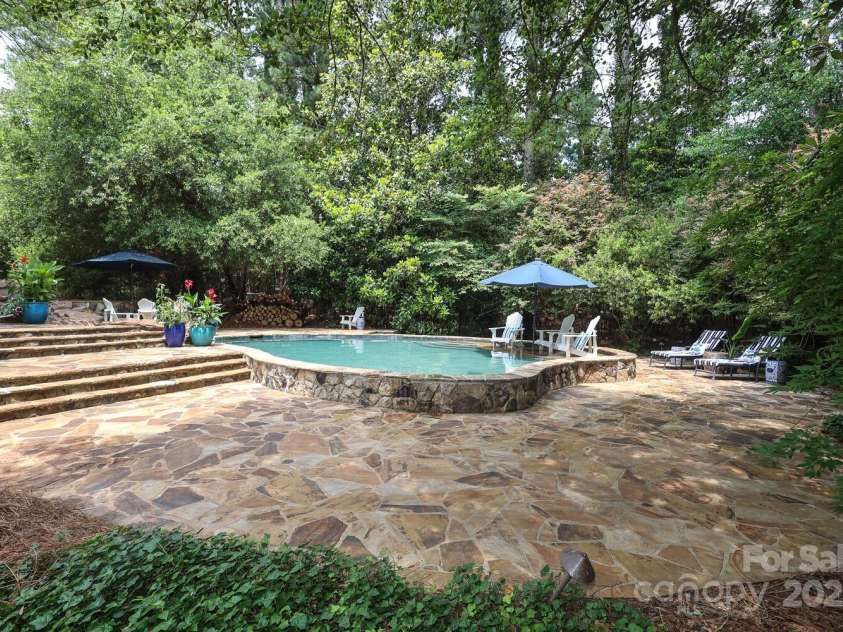 7794 Live Oaks Drive, Denver, NC 28037.  MLS# CAR4234292, YatesRealty ID 26852. Pool, spa and expansive flagstone pool deck Main house