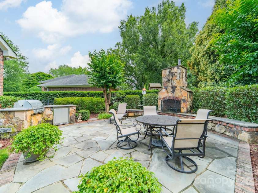 2300 Richardson Drive, Charlotte, NC 28211.  MLS# CAR4266822, YatesRealty ID 26854. Wood-burning outdoor fireplace, built-in grill, and refrigerator