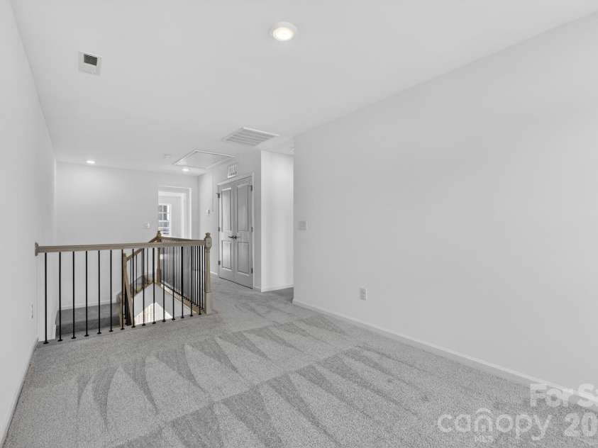 107 Nablus Trail, Mooresville, NC 28117.  MLS# CAR4350813, YatesRealty ID 26857. Gorgeous open rail loft on 3rd floor