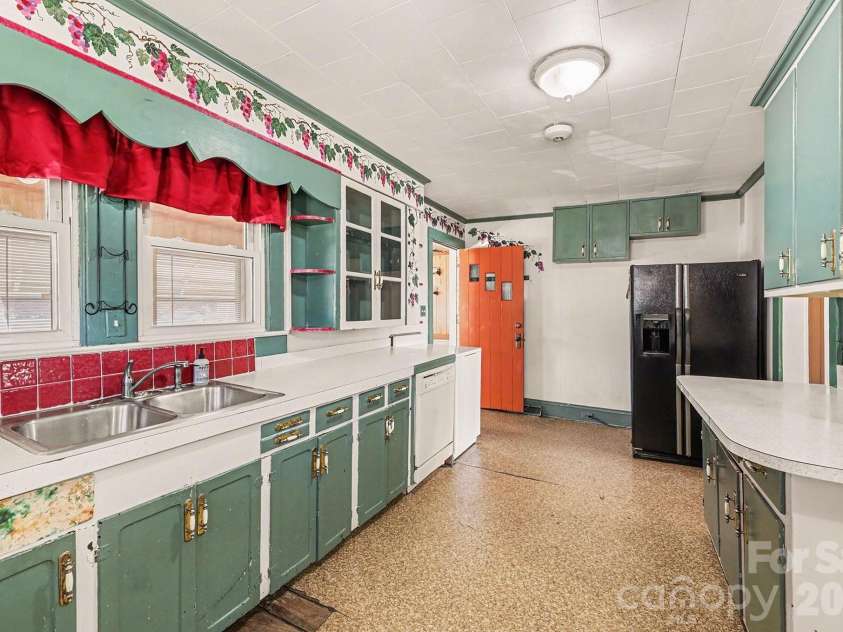 301 Gold Hill Drive, Salisbury, NC 28146.  MLS# CAR4337770, YatesRealty ID 2687. A cheerful kitchen with a nice amount of cabinet space, double stainless steel sink, Frigidaire Gallery side by side refrigerator, and dishwasher.