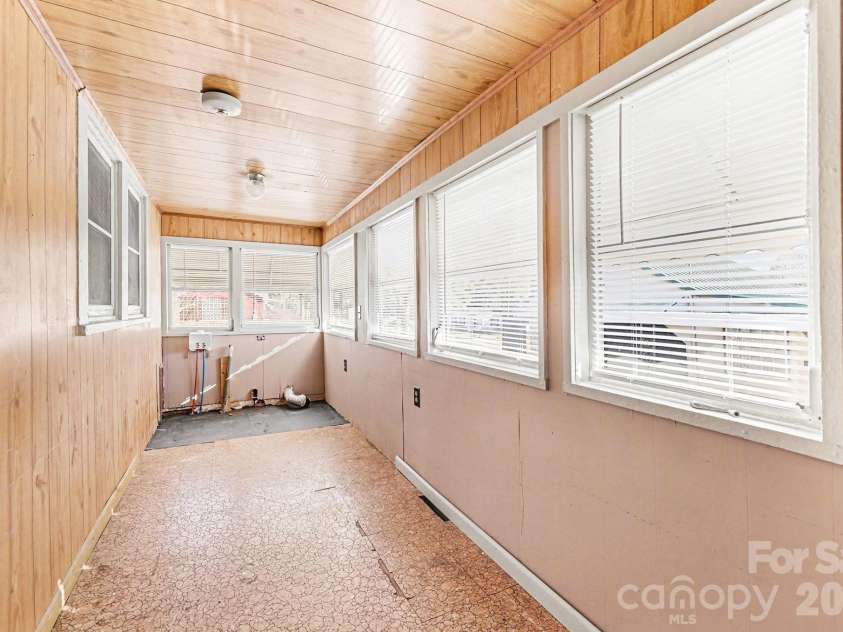 301 Gold Hill Drive, Salisbury, NC 28146.  MLS# CAR4337770, YatesRealty ID 2687. The enclosed back porch is heated. This view shows the laundry hookups. At the other end is a countertop with a cabinet underneath.