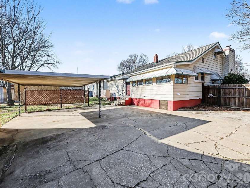 301 Gold Hill Drive, Salisbury, NC 28146.  MLS# CAR4337770, YatesRealty ID 2687. This covered area was originally a carport and lines up with the entrance for Reynolds Street. It would serve equally well as a covered patio. 