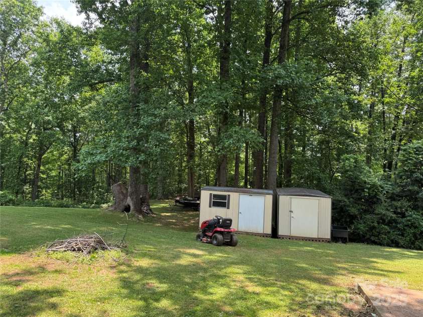 136 Christopher Road, Marion, NC 28752.  MLS# CAR4267352, YatesRealty ID 26878. Back area outside of fence w/storage sheds