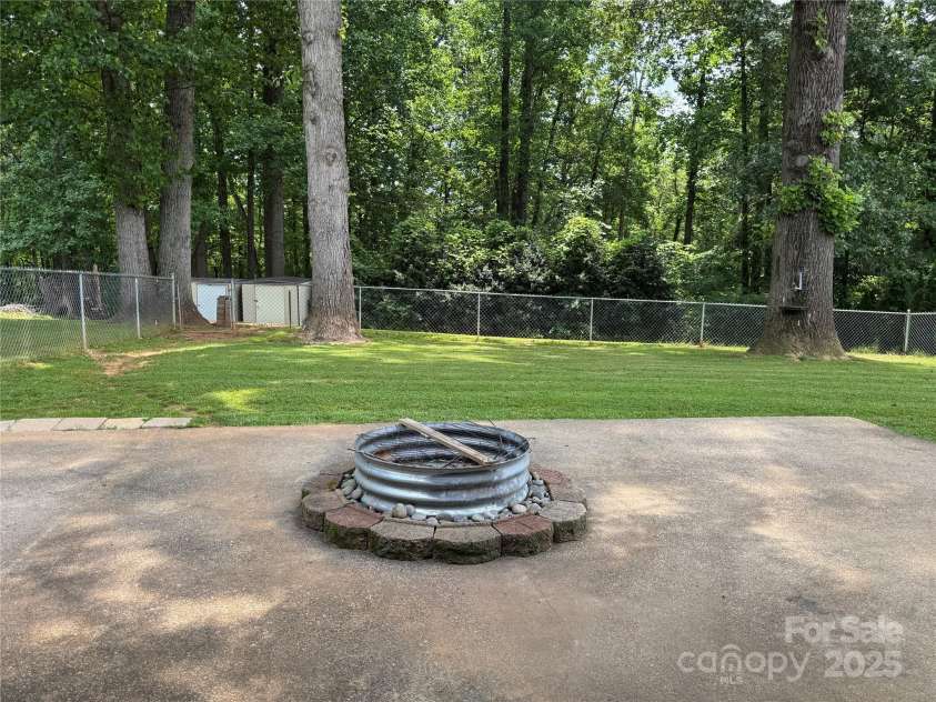 136 Christopher Road, Marion, NC 28752.  MLS# CAR4267352, YatesRealty ID 26878. Firepit just outside screened in patio