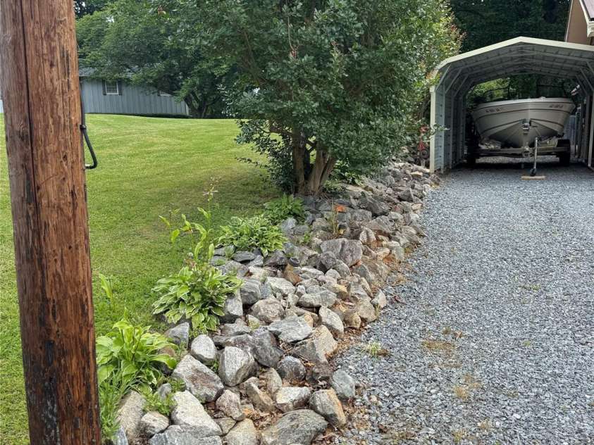 136 Christopher Road, Marion, NC 28752.  MLS# CAR4267352, YatesRealty ID 26878. Rocked landscaped area along driveway