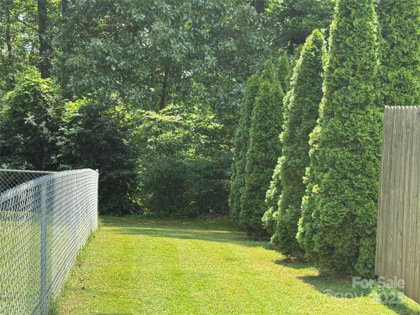 136 Christopher Road, Marion, NC 28752.  MLS# CAR4267352, YatesRealty ID 26878. Side yard outside of fence