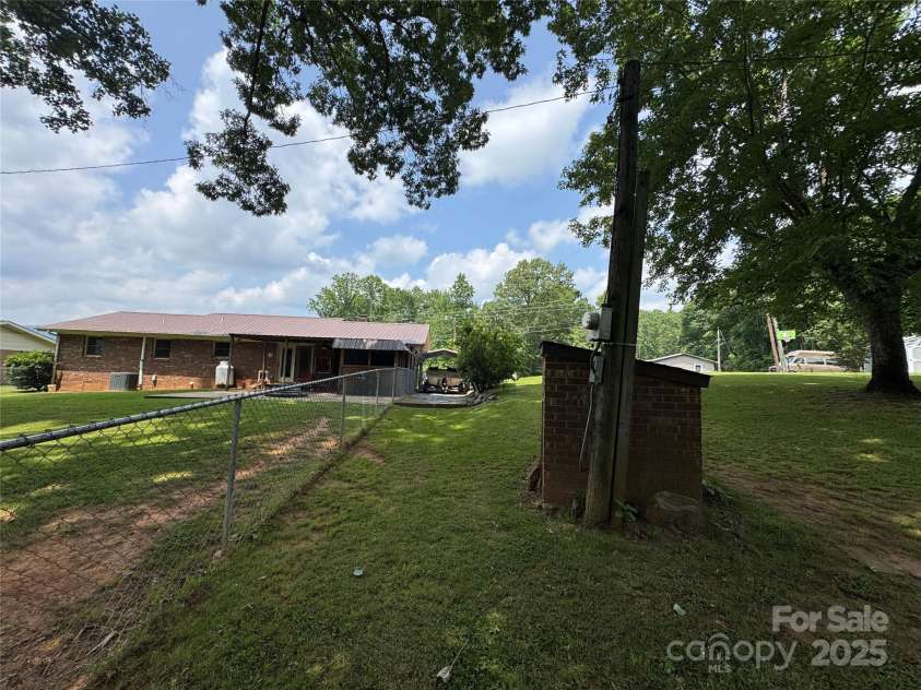 136 Christopher Road, Marion, NC 28752.  MLS# CAR4267352, YatesRealty ID 26878. View of back of house from outside the fence