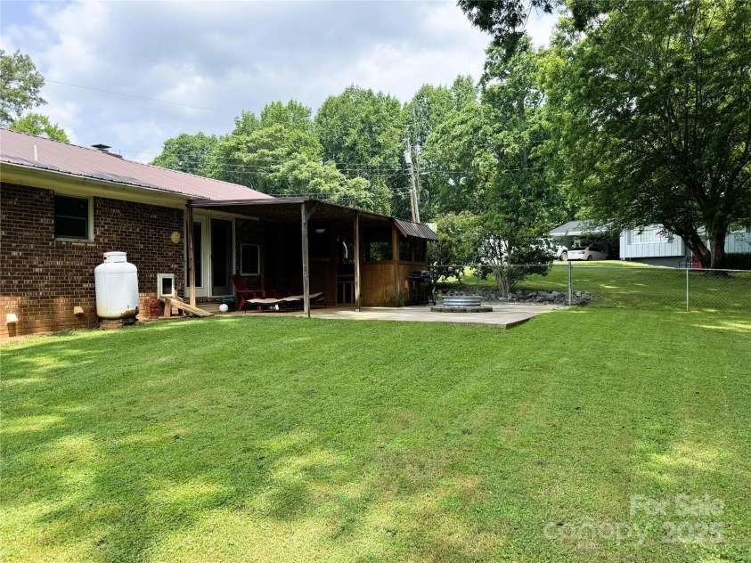 136 Christopher Road, Marion, NC 28752.  MLS# CAR4267352, YatesRealty ID 26878. View of back yard from the side