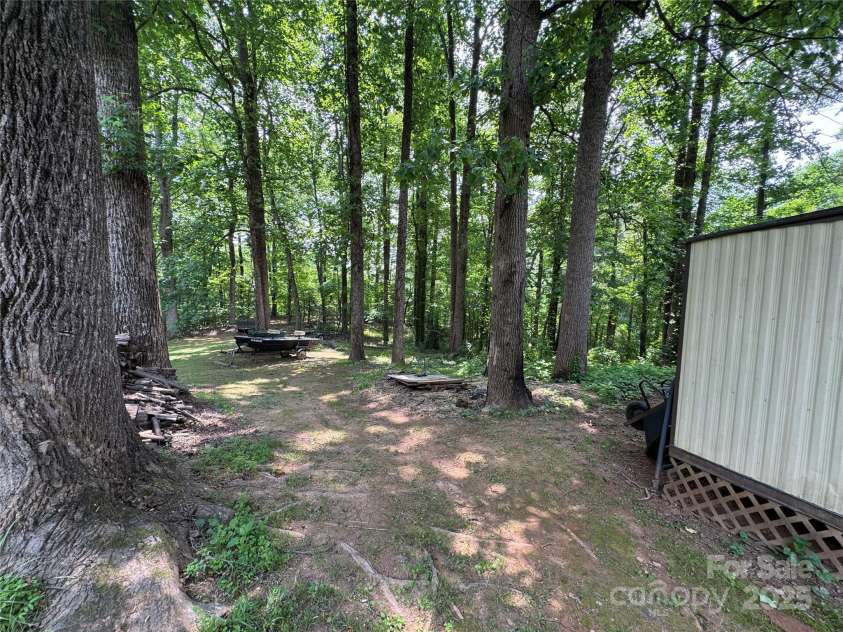 136 Christopher Road, Marion, NC 28752.  MLS# CAR4267352, YatesRealty ID 26878. Wooded area behind storage areas