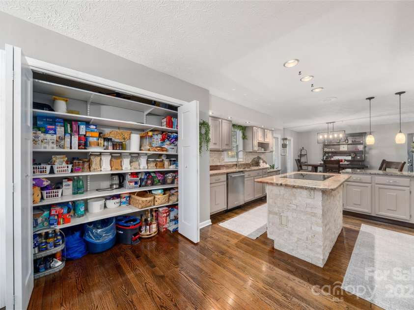 113 Pait Drive, Hendersonville, NC 28791.  MLS# CAR4218353, YatesRealty ID 2688. Large pantry with wooden shelves