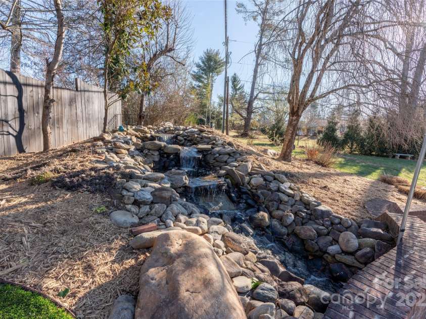 113 Pait Drive, Hendersonville, NC 28791.  MLS# CAR4218353, YatesRealty ID 2688. Waterfall above KOI pond