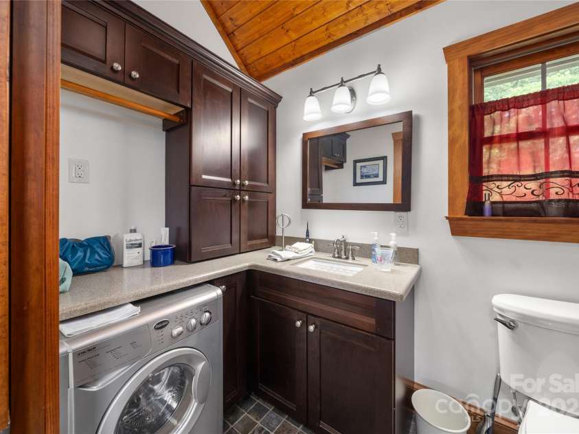4862 Pinnacle Mountain Road, Zirconia, NC 28790.  MLS# CAR4262983, YatesRealty ID 26893. Guest Cabin Laundry