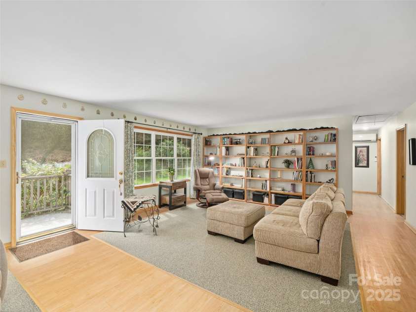 3829 Coxes Creek Road, Burnsville, NC 28714.  MLS# CAR4246043, YatesRealty ID 26911. Living Room with built-in Book shelving for  art or literature 