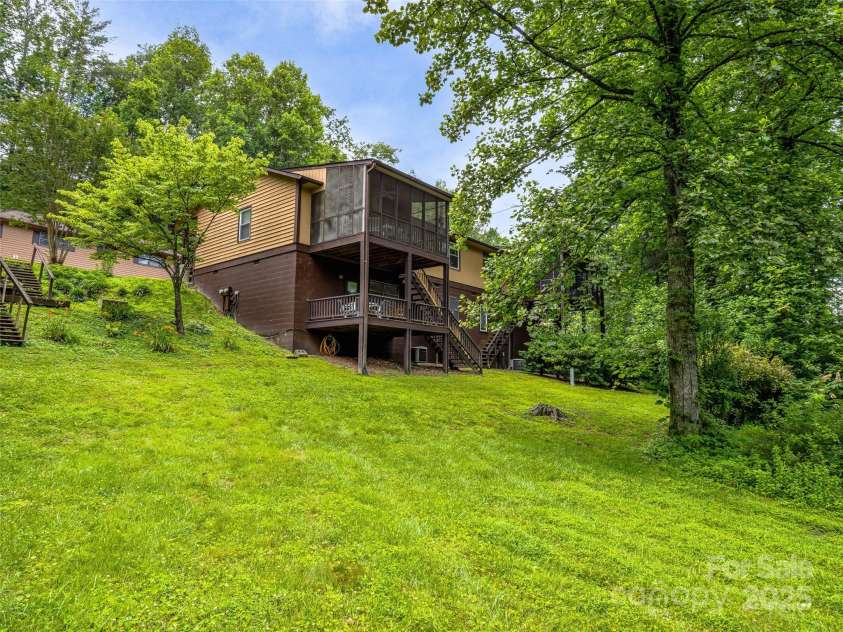 128 View De Lake Drive, Etowah, NC 28729.  MLS# CAR4274148, YatesRealty ID 26919. Enjoy Main level living with 2 decks boasting Pond and lush forest views!