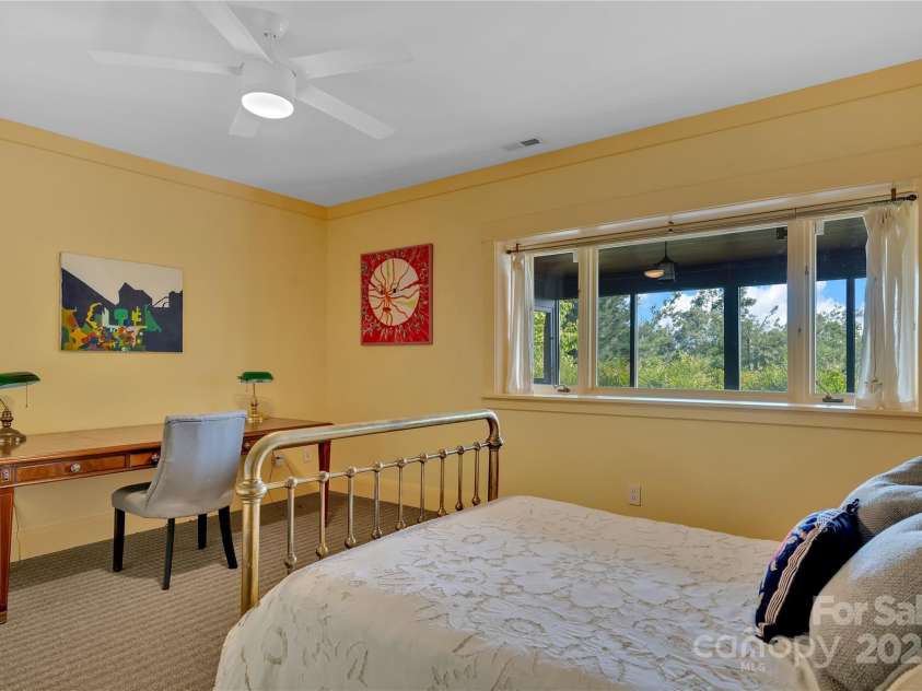 24 Westhaven Drive, Asheville, NC 28804.  MLS# CAR4269896, YatesRealty ID 26929. The second lower-level bedroom has a cedar closet and full bath acessed through a private hallway