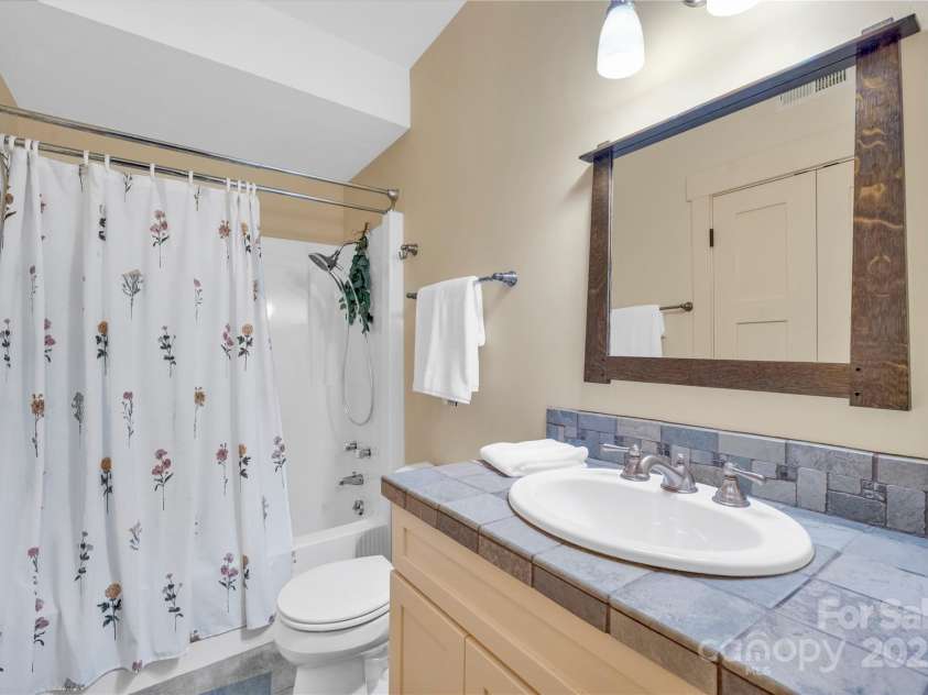 24 Westhaven Drive, Asheville, NC 28804.  MLS# CAR4269896, YatesRealty ID 26929. This full bath offers the only bathtub, offering a quiet cozy spot for relaxation