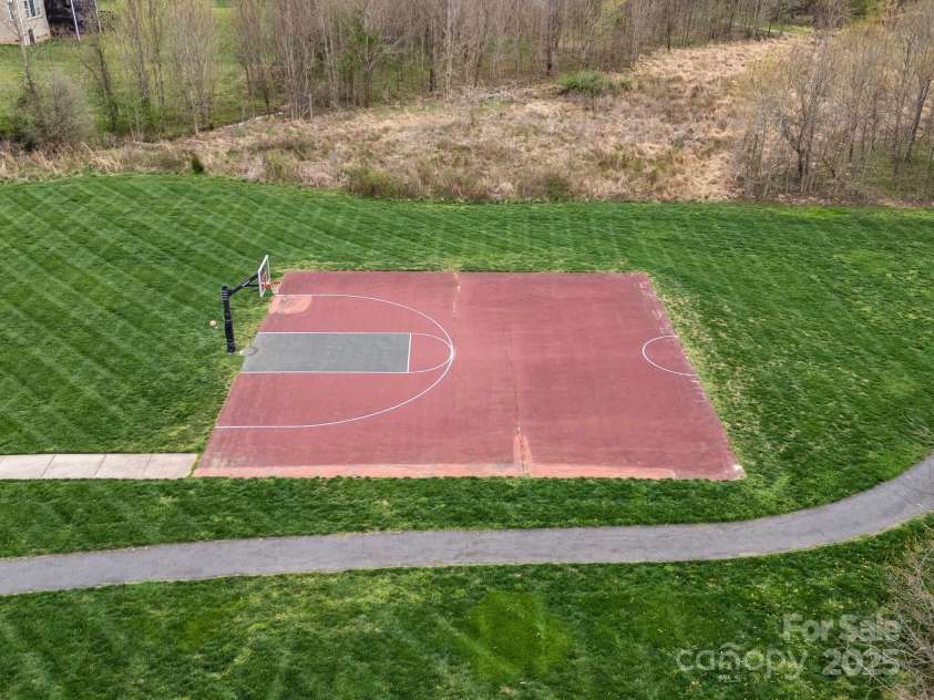 422 Deer Brush Lane, Waxhaw, NC 28173.  MLS# CAR4253488, YatesRealty ID 26930. Community basketball court and a peek at the walking trail.