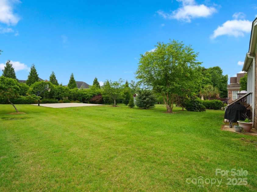 422 Deer Brush Lane, Waxhaw, NC 28173.  MLS# CAR4253488, YatesRealty ID 26930. Great backyard with plenty of grassy area for play or gardens plus your very own basketball court.