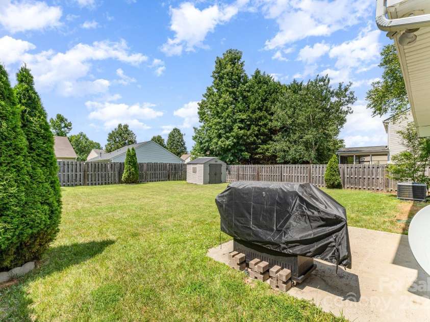 10506 Gold Pan Road, Charlotte, NC 28215.  MLS# CAR4280921, YatesRealty ID 26948. Open backyard with plenty of room for activities - convenient patio right off back door for barbecue