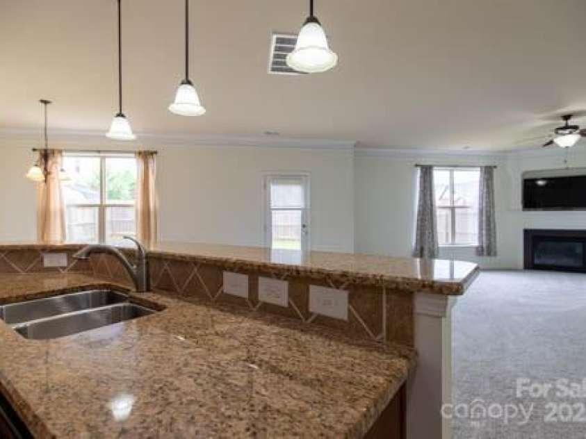159 Saye Place, Mooresville, NC 28115.  MLS# CAR4255738, YatesRealty ID 26952. Kitchen Island with Eat-In Seating Area opens into Living Room
