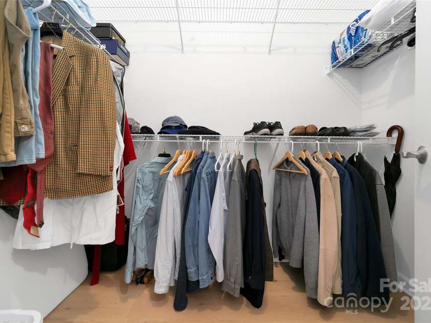 99 Ridgetop Circle, Brevard, NC 28712.  MLS# CAR4282824, YatesRealty ID 26984. Primary Suite Walk in Closet located between the bedroom and bathroom. Lots of great storage space, shelving and hangar room.