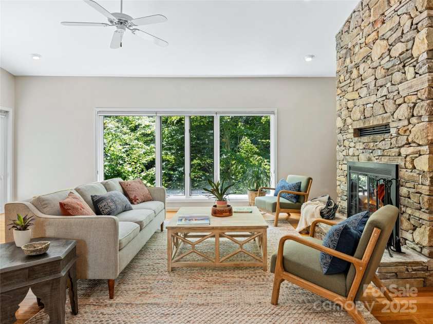 150 Sondley Parkway, Asheville, NC 28805.  MLS# CAR4280880, YatesRealty ID 26990. Stacked Stone Fire Place. Picture windows overlooking lush yard