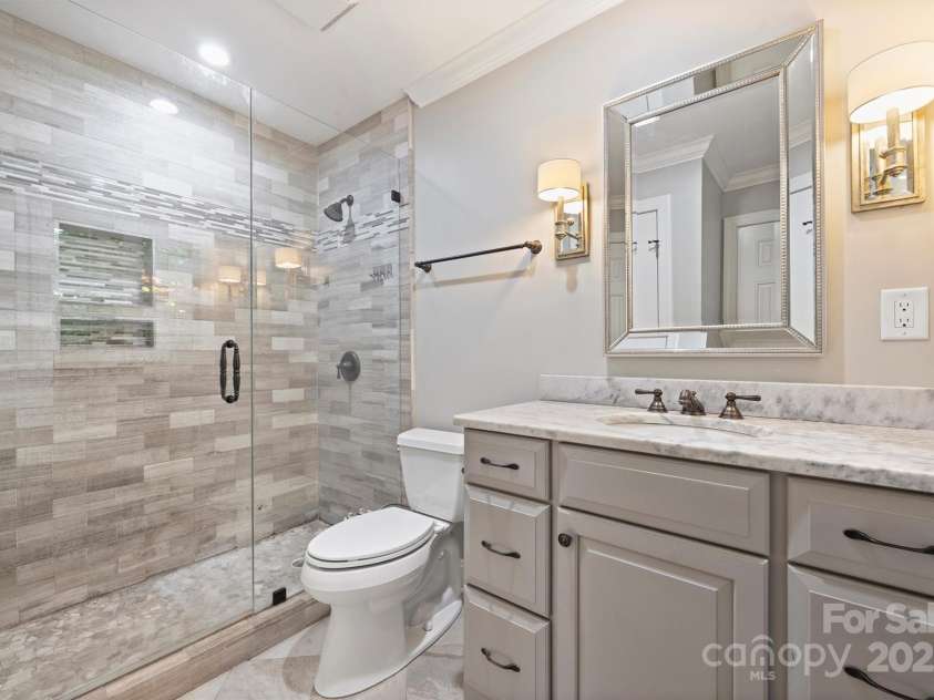 1008 Dumbarton Road, Gastonia, NC 28054.  MLS# CAR4275369, YatesRealty ID 26994. Ensuite bathroom off of the second primary suite. Another frameless shower and upgraded vanity.
