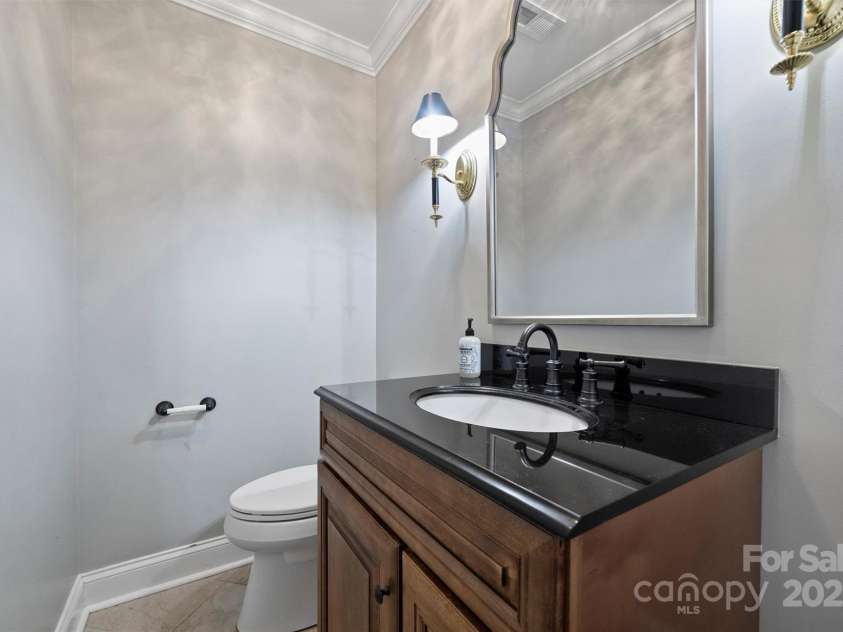 1008 Dumbarton Road, Gastonia, NC 28054.  MLS# CAR4275369, YatesRealty ID 26994. Half bath with granite countertop off of the family room.