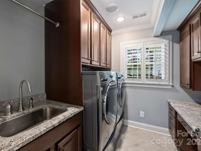 1008 Dumbarton Road, Gastonia, NC 28054.  MLS# CAR4275369, YatesRealty ID 26994. Laundry room has granite countertops, a wash sink, and built-ins!