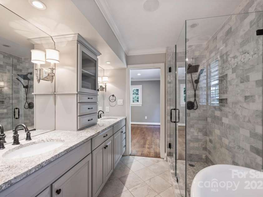 1008 Dumbarton Road, Gastonia, NC 28054.  MLS# CAR4275369, YatesRealty ID 26994. Luxurious primary bath with granite countertops, dual sinks, surround sound, tiled frameless shower and soaking tub!