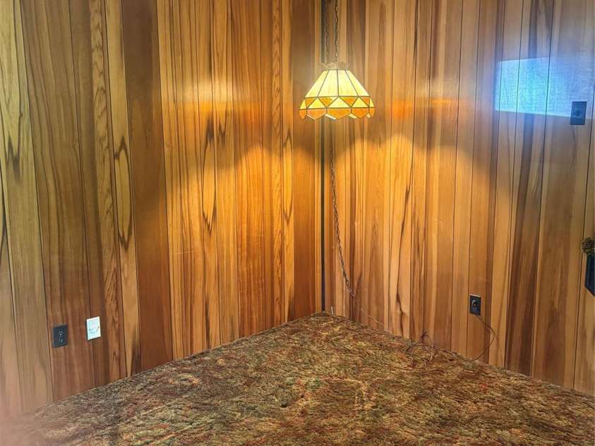 5806 Whitingham Drive, Charlotte, NC 28215.  MLS# CAR4263834, YatesRealty ID 27000. Lower level, den with corner view. Lower Level. Beautiful Peruvian Rosewood paneling.