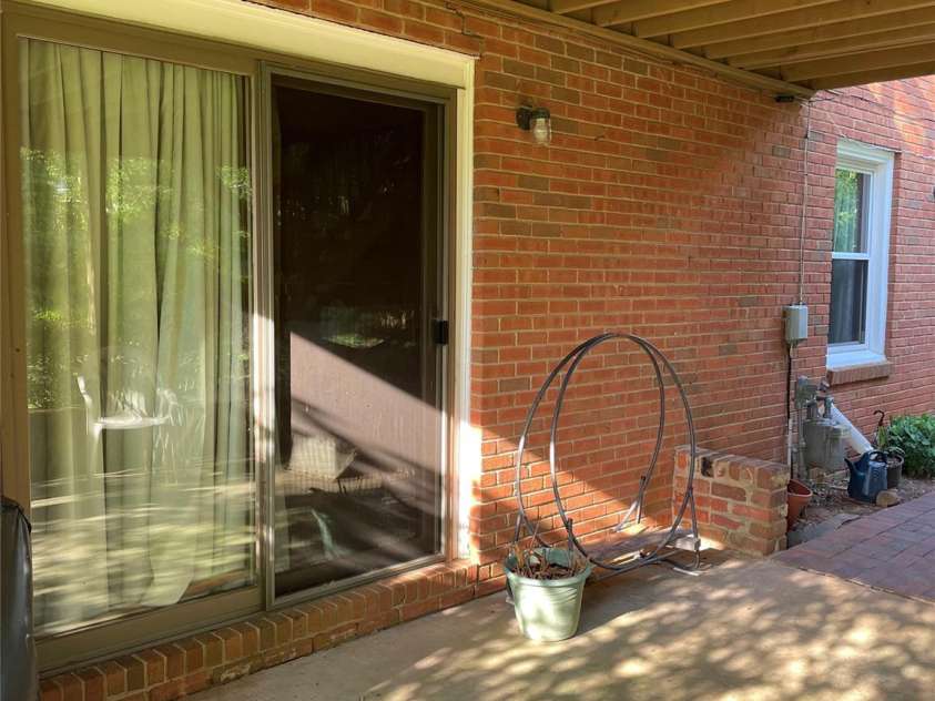 5806 Whitingham Drive, Charlotte, NC 28215.  MLS# CAR4263834, YatesRealty ID 27000. Lower level view of patio leading from the den. 