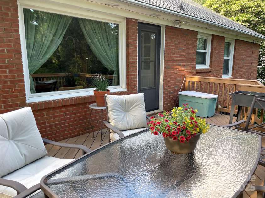 5806 Whitingham Drive, Charlotte, NC 28215.  MLS# CAR4263834, YatesRealty ID 27000. View of deck wth patio furniture. Also able to see the full brick exterior of the home. 