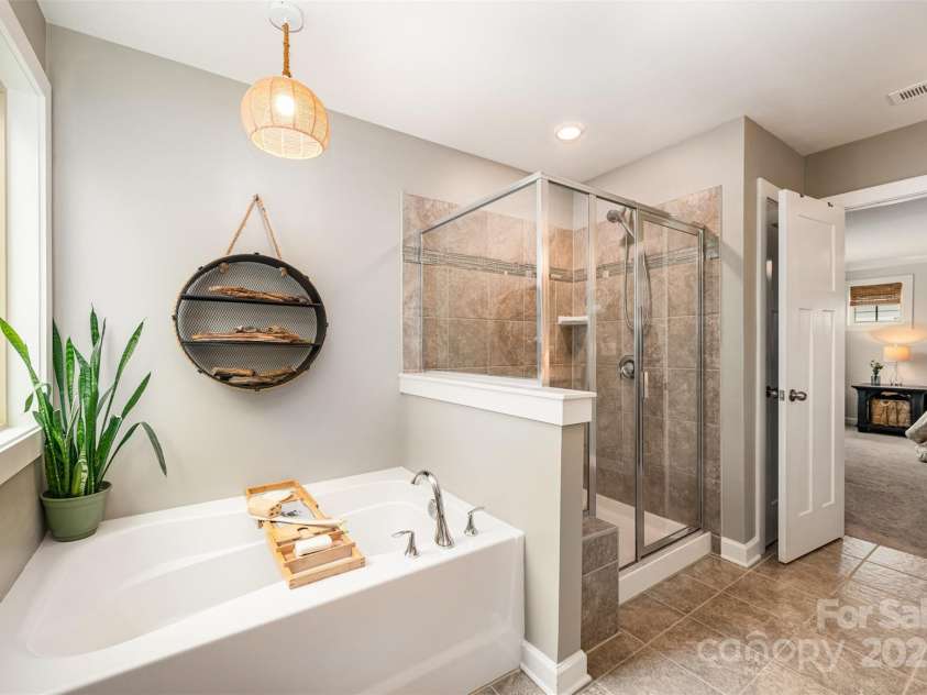 915 Claires Creek Lane, Davidson, NC 28036.  MLS# CAR4264930, YatesRealty ID 27003. Primary bath with soaking tub and walk-in shower