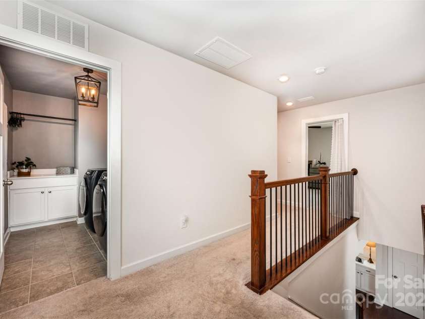 915 Claires Creek Lane, Davidson, NC 28036.  MLS# CAR4264930, YatesRealty ID 27003. Upstairs laundry with new chandelier