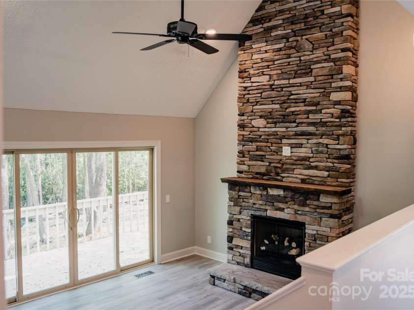 136 Day Drive, Boone, NC 28607.  MLS# CAR4270315, YatesRealty ID 27004. Den with deck access & stone fireplace!