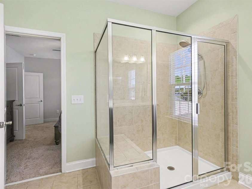 2020 Cramer Place Court, Cramerton, NC 28032.  MLS# CAR4368017, YatesRealty ID 27009. Primary bathroom with tiled shower and seating inside