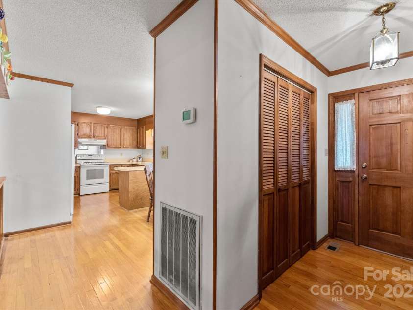 310 Oakwood Drive, Mount Holly, NC 28120.  MLS# CAR4297831, YatesRealty ID 2701. View from hallway back towards kitchen