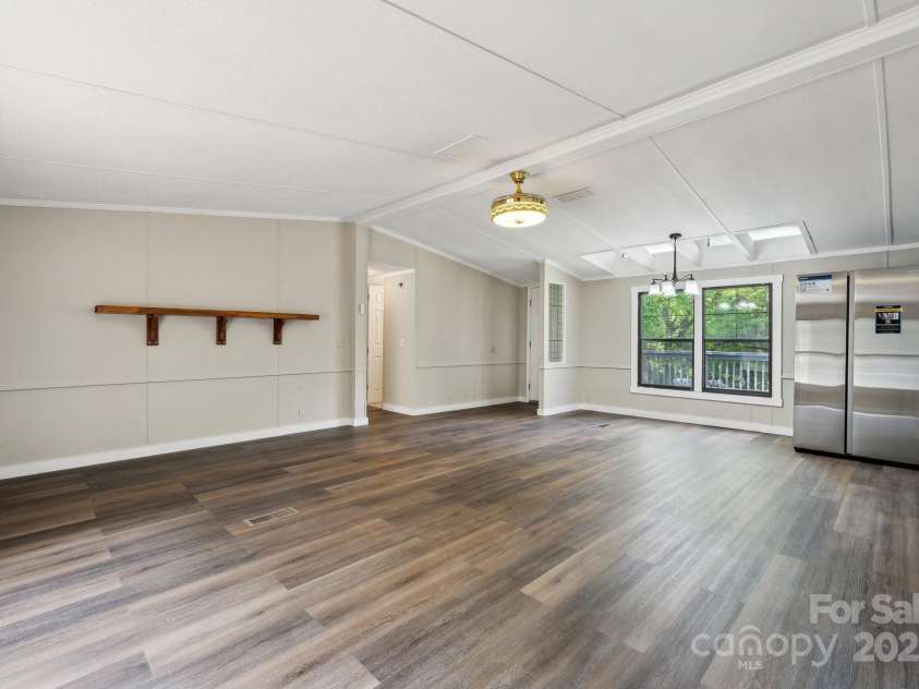 5001 Grand Canyon Road, Concord, NC 28027.  MLS# CAR4256169, YatesRealty ID 27021. Open Floorplan of Living Room leading into the Kitchen