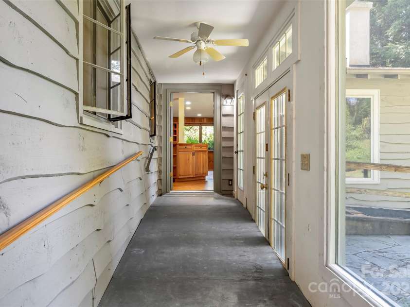 17 Park Road, Asheville, NC 28803.  MLS# CAR4278105, YatesRealty ID 27028. Previously part of the home's exterior, this hallway was created when enclosed to connect the bonus room and kitchen/living area.